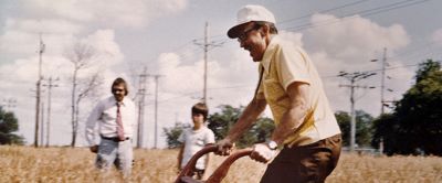 historic picture of man hand plowing a field of wheat